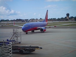 a blue and red airplane on the tarmac