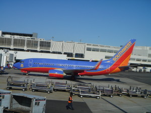 a blue and orange airplane at an airport