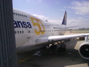 a large white airplane with yellow writing on it