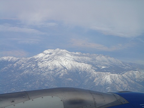 a view of a snowy mountain from an airplane window