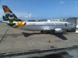 a white airplane with colorful tail fin